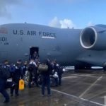 U.s. Air Force Aircraft On Tarmac With Florida Task Force 2 Rescue Personnel Boarding.