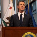 California Gov. Gavin Newsom Speaking At A Podium In 2020.