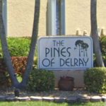 Entrance Sign And Gated Entry To The Pines Of Delray Condominium Community In Delray Beach, Florida.