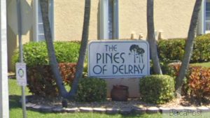 Entrance Sign And Gated Entry To The Pines Of Delray Condominium Community In Delray Beach, Florida.