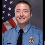 Christopher Randazzo In His Coral Springs Fire Department Uniform, Posed In Front Of An American Flag, In An Official Portrait Released By The Department.