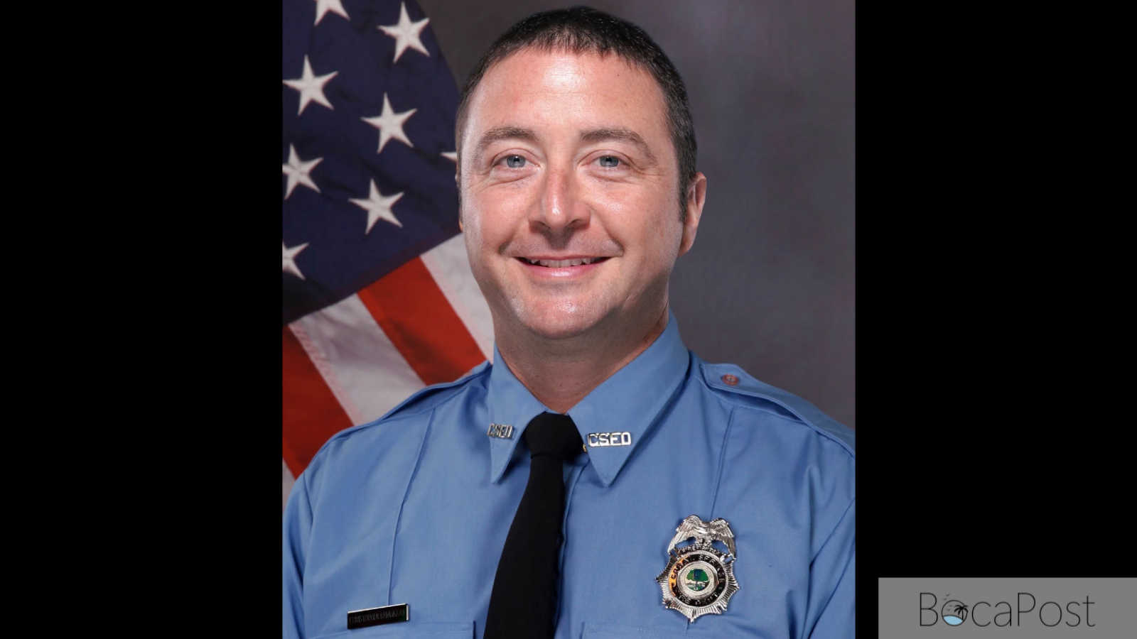 Christopher Randazzo in his Coral Springs Fire Department uniform, posed in front of an American flag, in an official portrait released by the department.