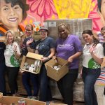 Volunteers Packing Cardboard Kidspack Food Boxes For The Boca Helping Hands Weekend Meal Program.