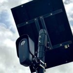 Flock Safety License Plate Reader Camera Mounted On A Pole Along A Coral Springs Street.