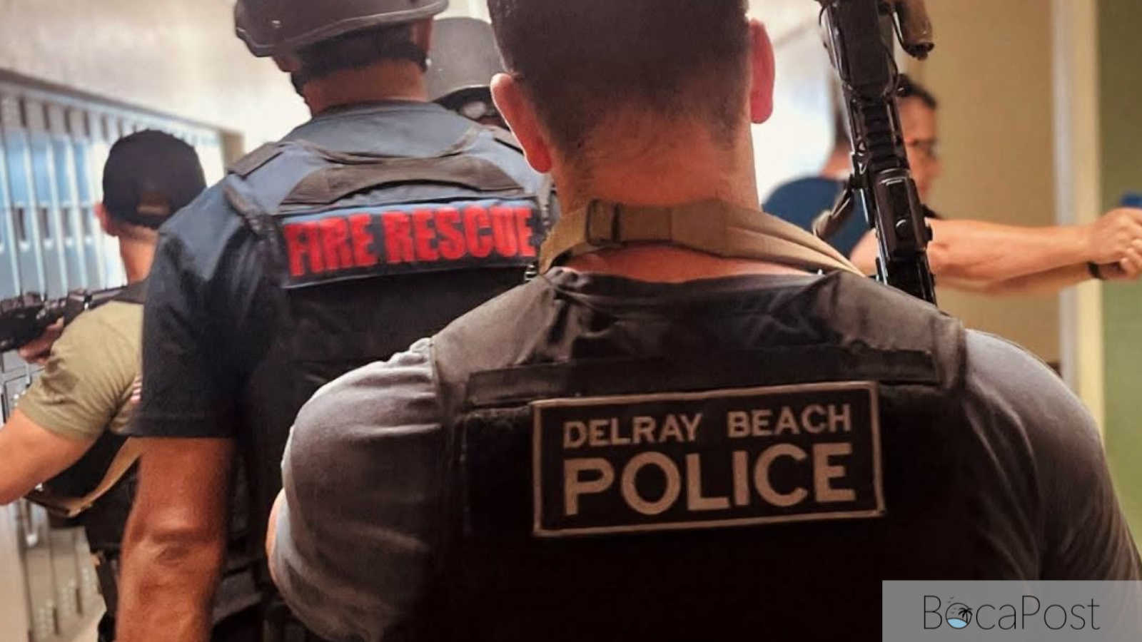 Delray Beach Police officers in tactical gear enter a school building during an active shooter training exercise at Atlantic Community High School.