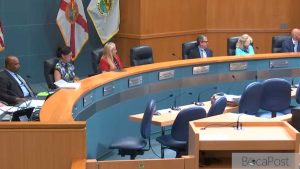 Palm Beach County Commissioners Seated At The Dais During A County Commission Meeting.